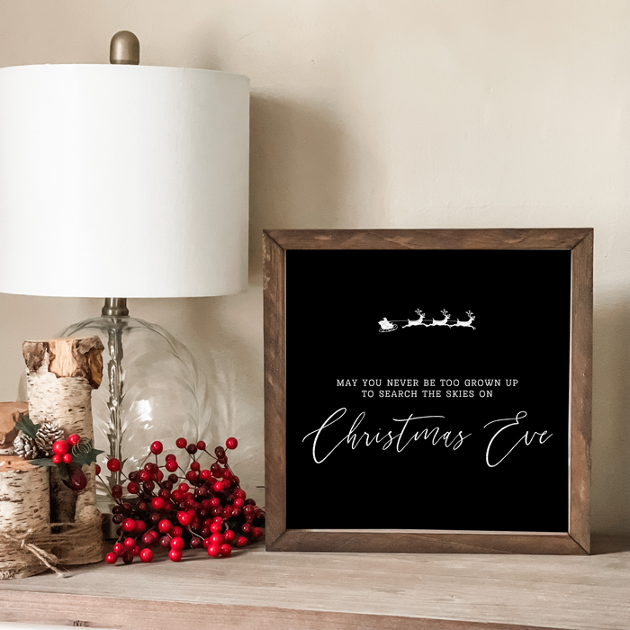 May you Never be too grown up to search the skies on Christmas Eve sign. 